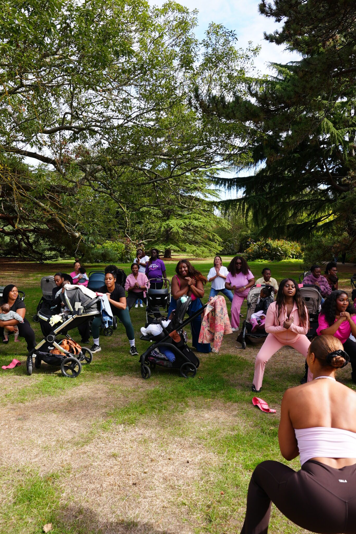 Black mums and babies taking part in a community wellbeing session in Greenwich Park
